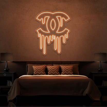 orange dripping chanel neon sign hanging on bedroom wall
