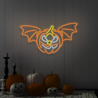 orange flying pumpkin neon sign hanging on wall above pumpkins