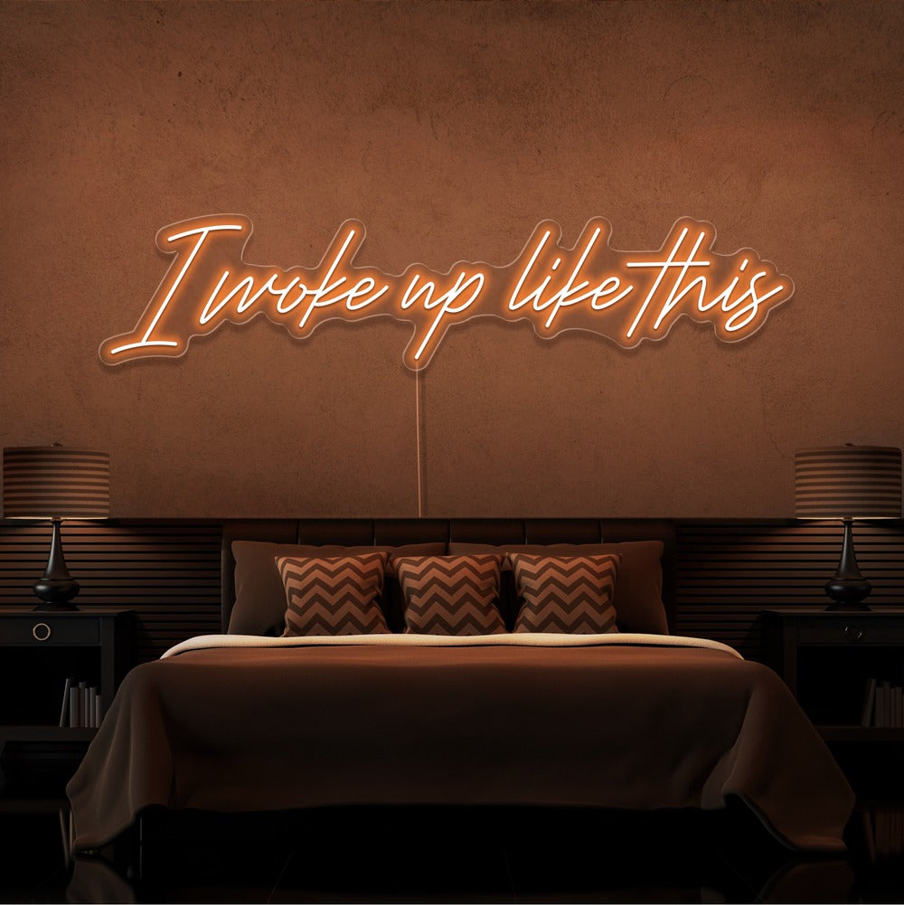 orange i woke up like this neon sign hanging on bedroom wall