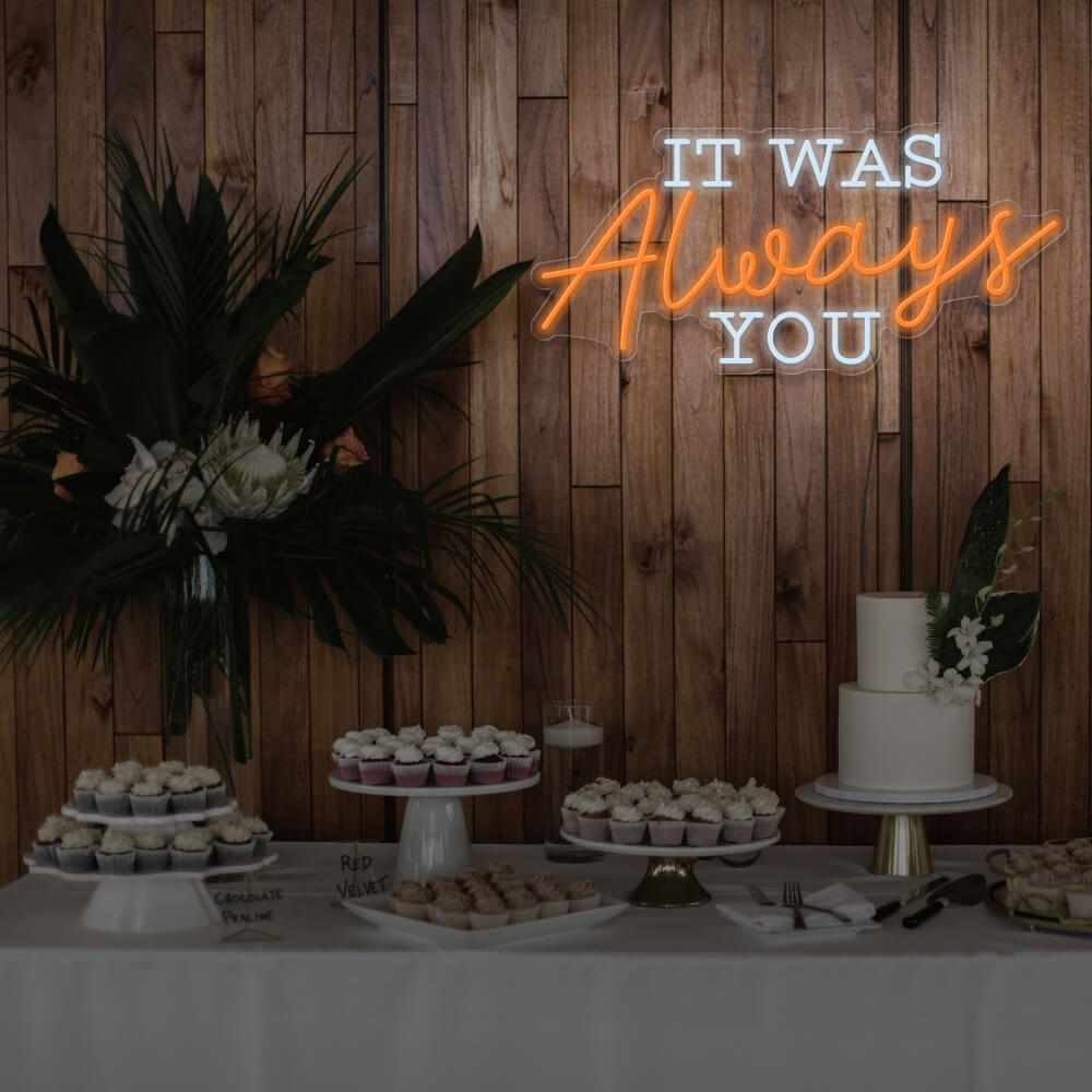 orange it was always you neon sign hanging above dessert table