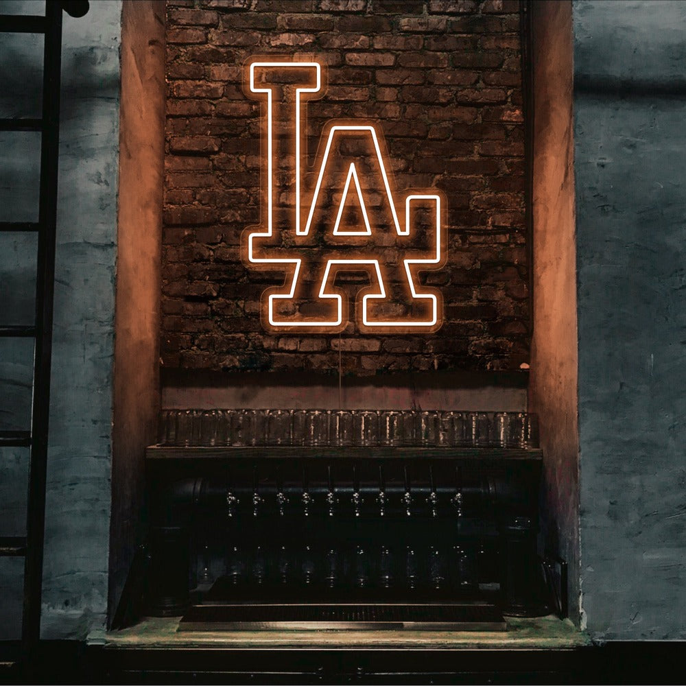 orange LA neon sign hanging on bar wall