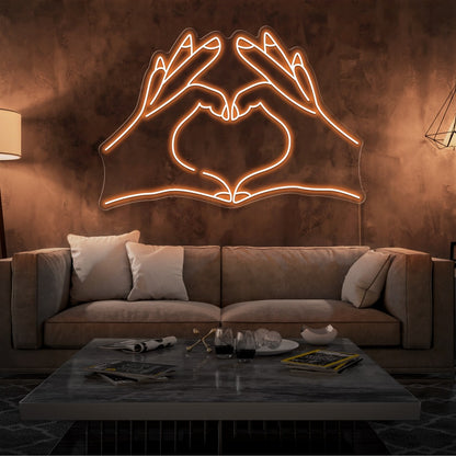 orange love hands neon sign hanging on living room wall