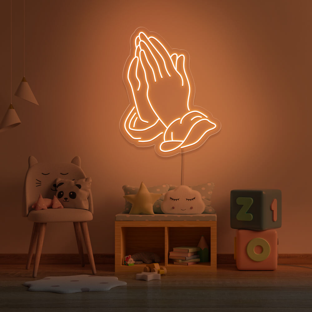 orange praying hands neon sign hanging on kids bedroom wall