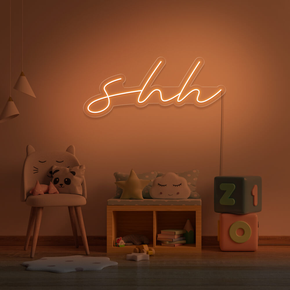 orange shh neon sign hanging on kids bedroom wall