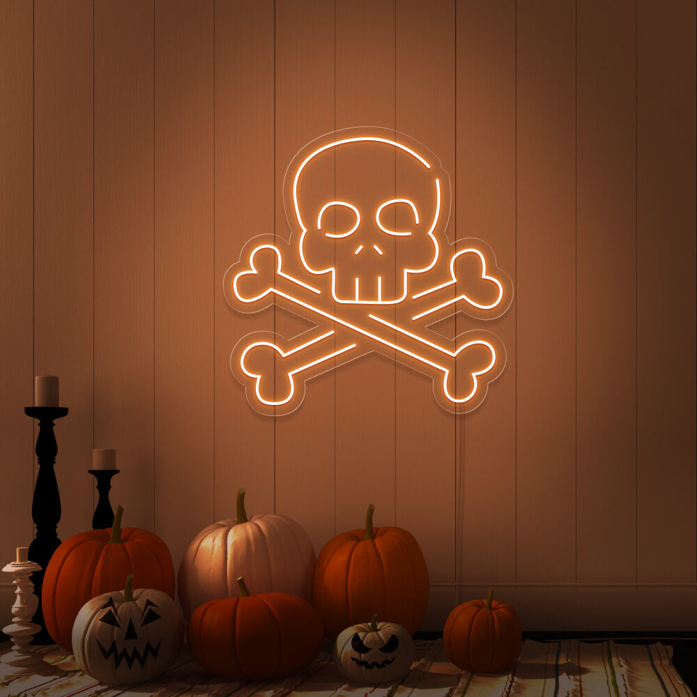 orange skull bones neon sign with pumpkins on floor