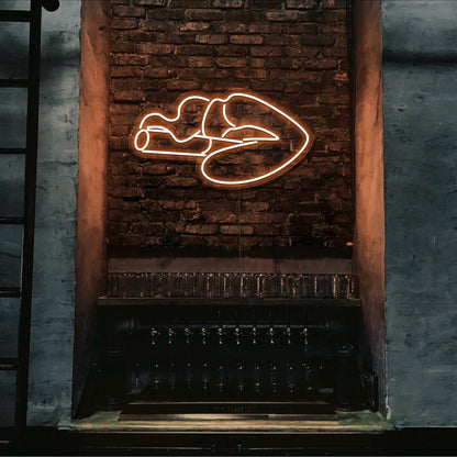 orange smoking lips neon sign hanging on bar wall