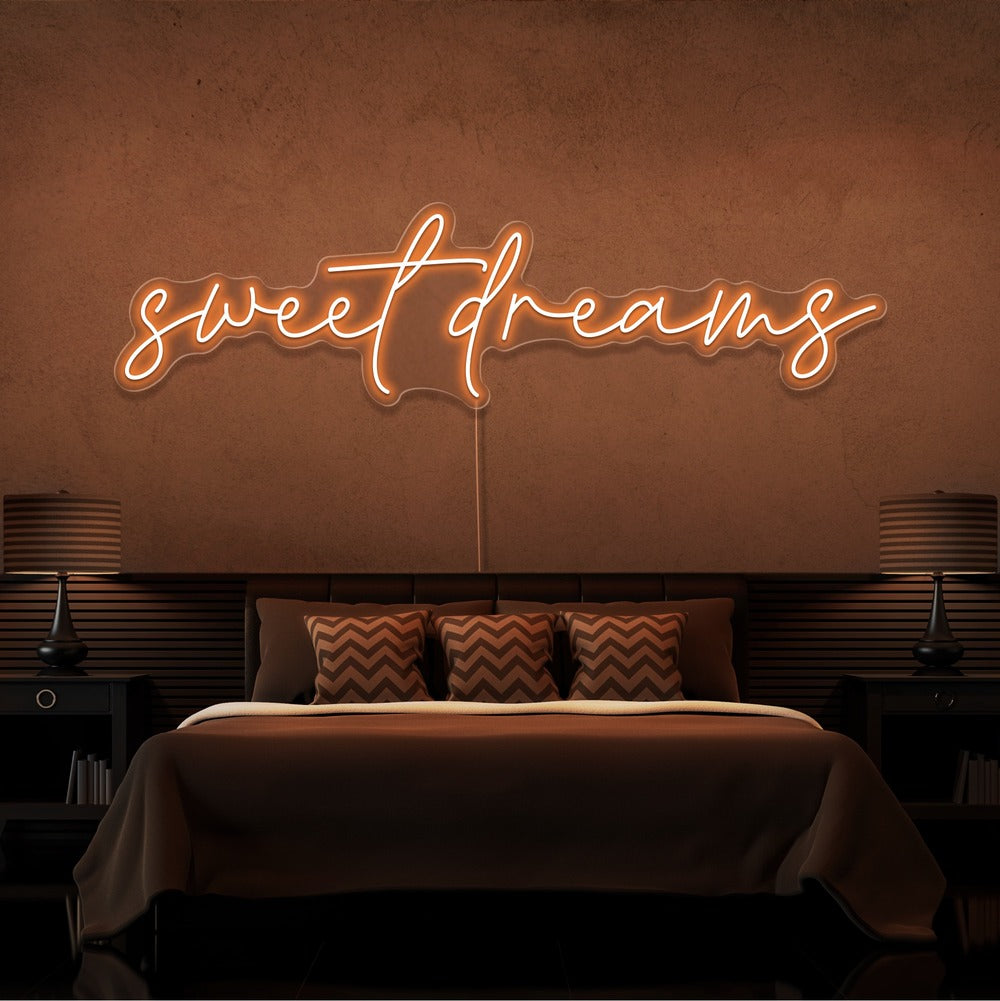 orange sweet dreams neon sign hanging on bedroom wall