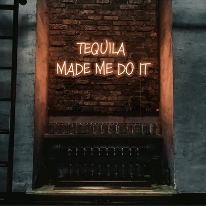 orange tequila made me do it neon sign hanging on bar wall