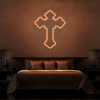 orange tupac cross neon sign hanging on bedroom wall