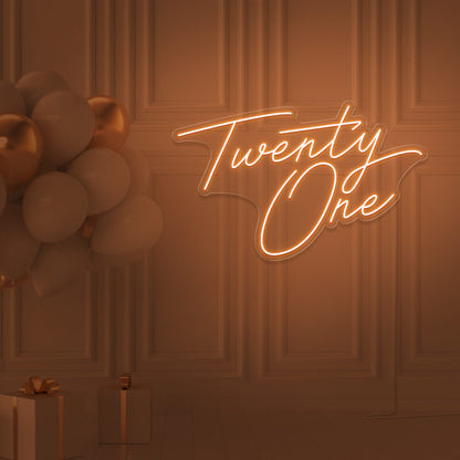 orange  twenty one neon sign hanging on wall with balloons