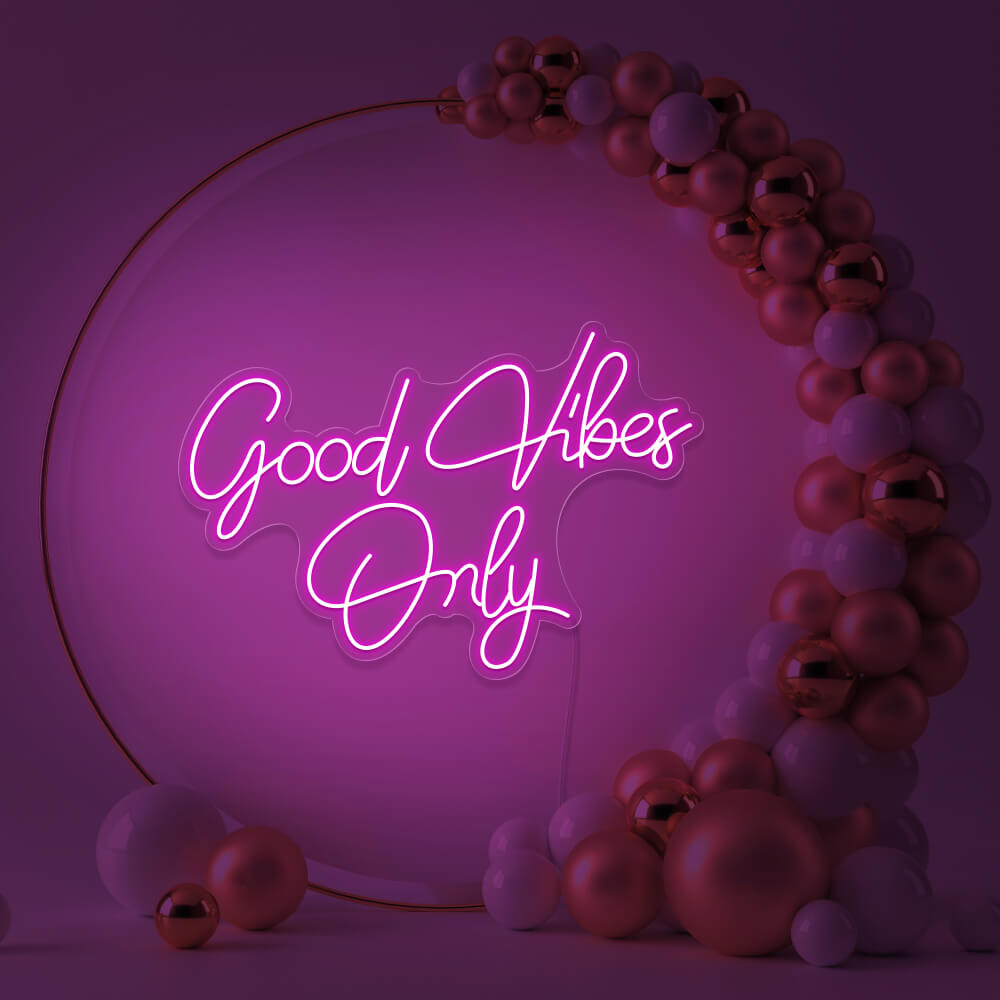 hot pink good vibes only neon sign hanging inside balloon hoop backdrop