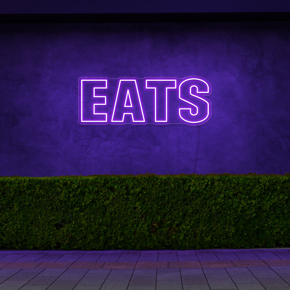 purple eats neon sign hanging on outside wall