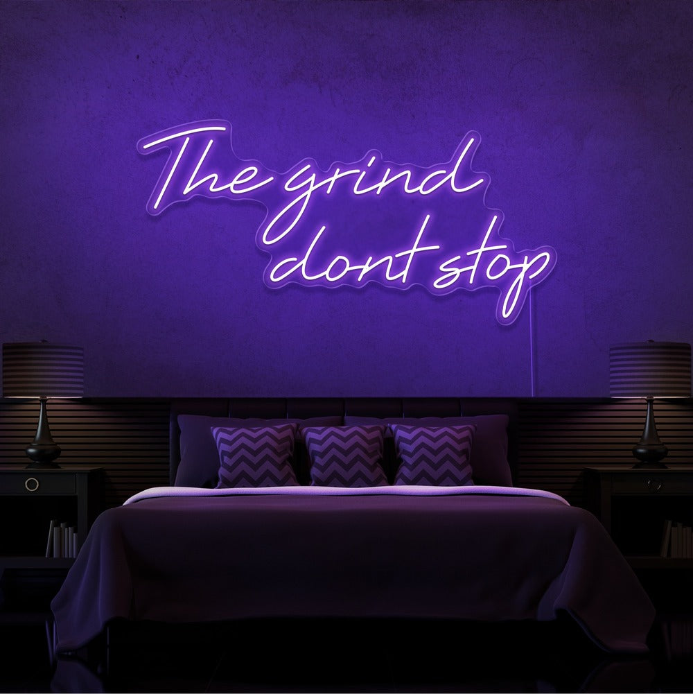 red the grind dont stop neon sign hanging on bedroom wall