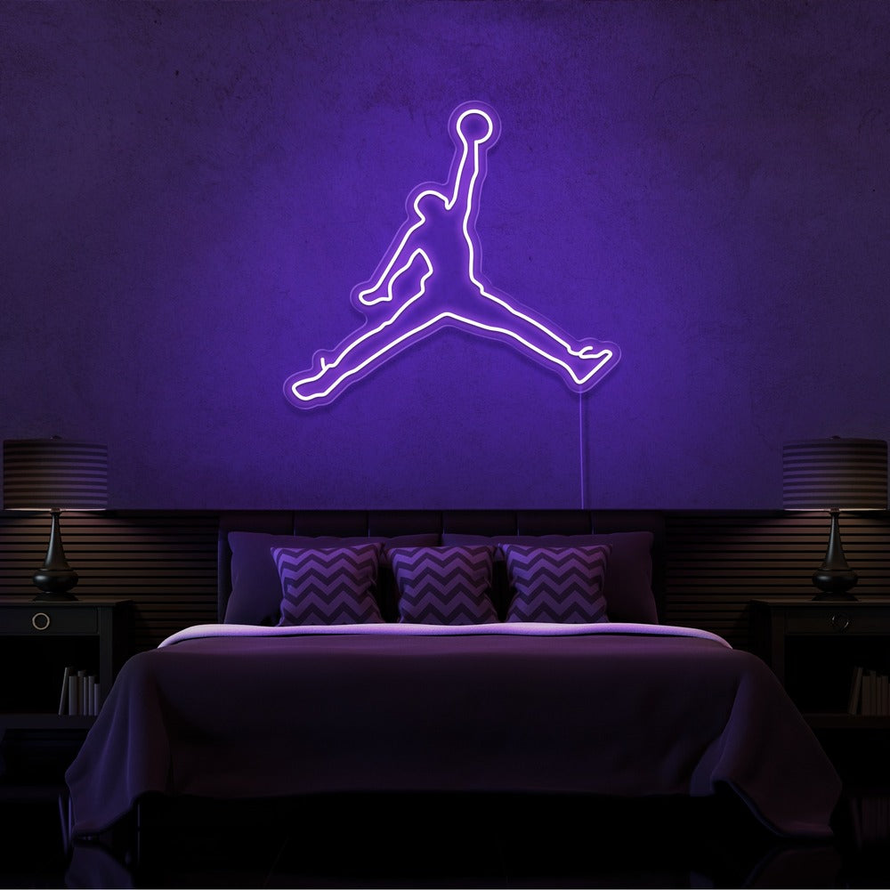 purple jordan jumpman neon sign hanging on bedroom wall