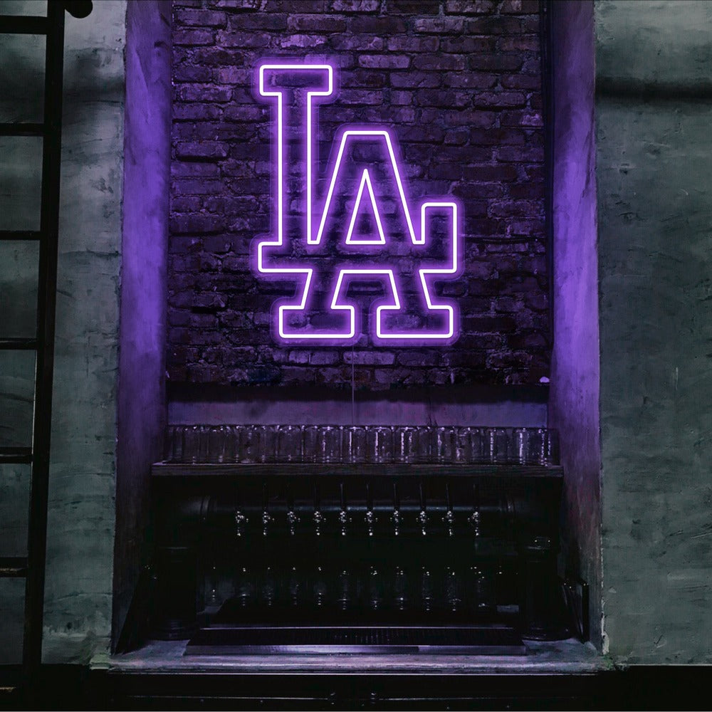 purple LA neon sign hanging on bar wall