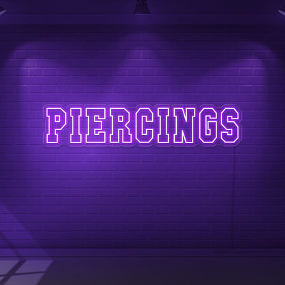 purple piercings neon sign hanging on wall