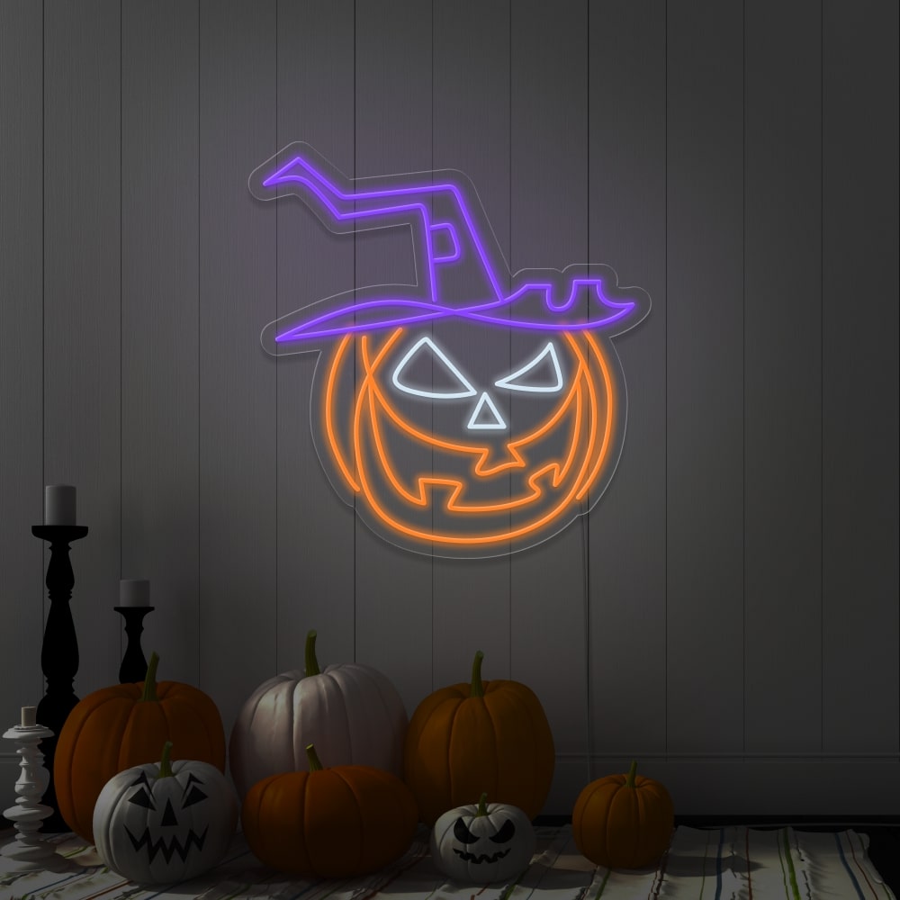 purple pumpkin hat neon sign hanging on wall next to pumpkins