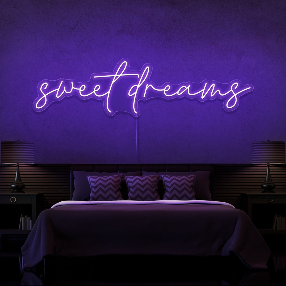 purple sweet dreams neon sign hanging on bedroom wall