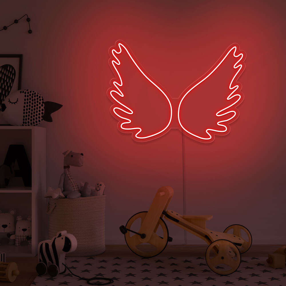 red angel wings neon sign hanging on kids bedroom wall