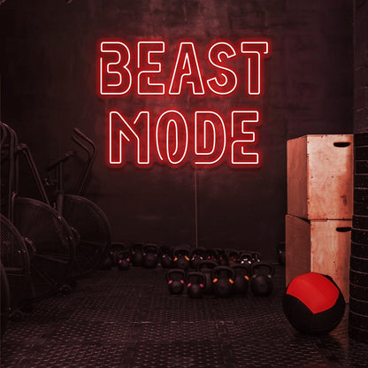 red beast mode neon sign hanging on gym wall