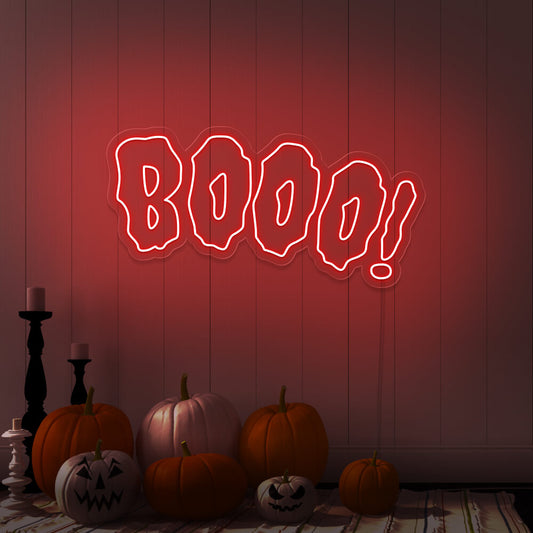 red boo neon sign with halloween pumpkins on floor