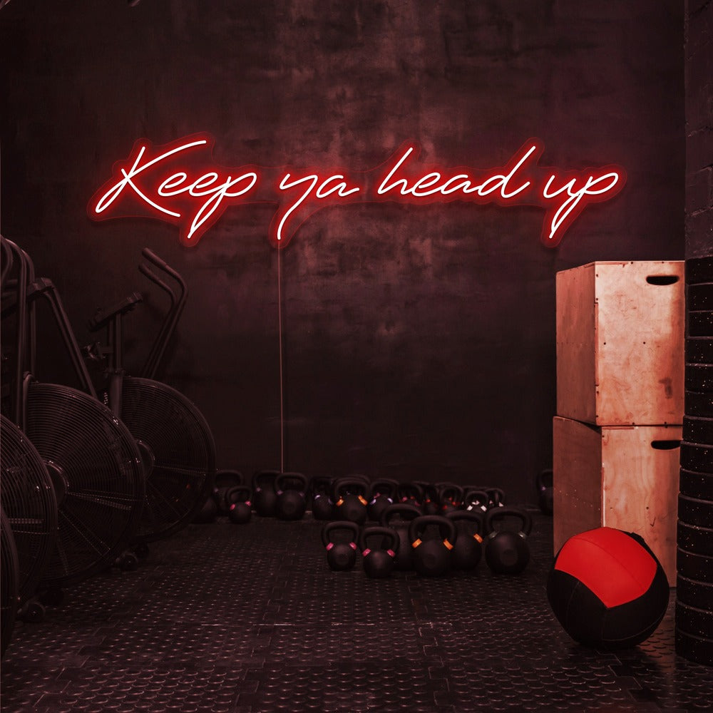 red keep ya head up neon sign hanging on gym wall