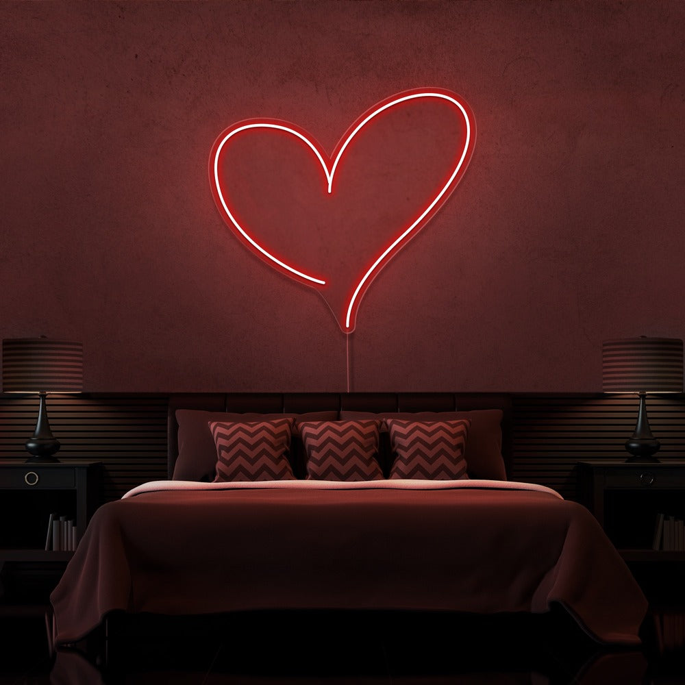 red love heart neon sign hanging on bedroom wall