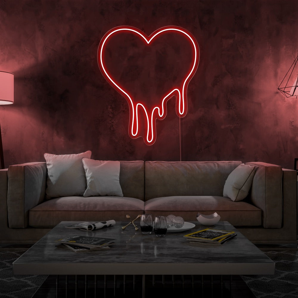 red melting heart neon sign hanging on living room wall