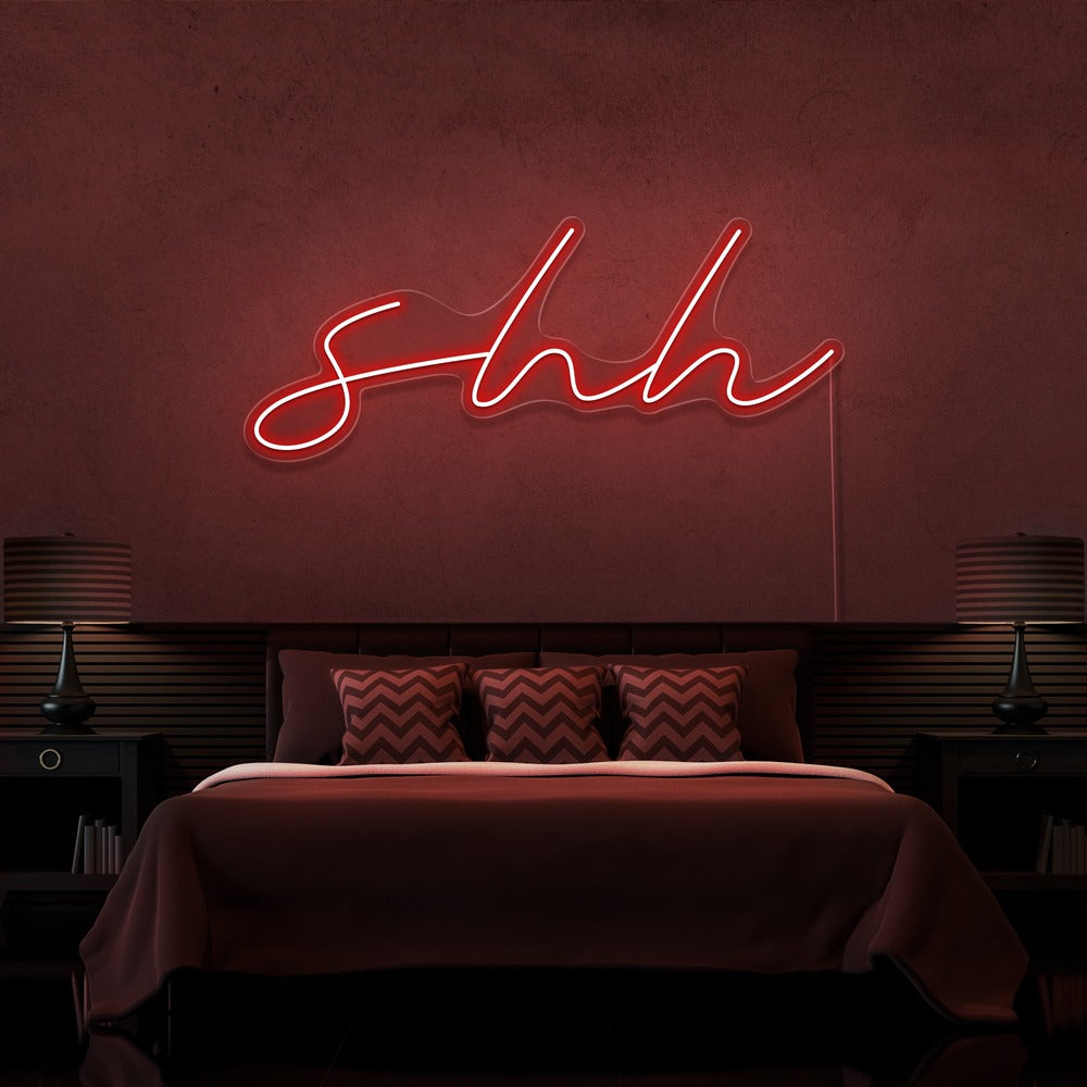red shh neon sign hanging on bedroom wall