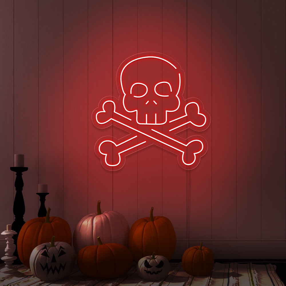 red skull bones neon sign with pumpkins on floor