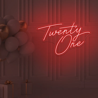 red  twenty one neon sign hanging on wall with balloons