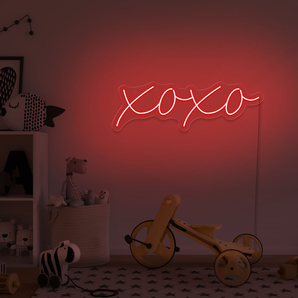 red xoxo neon sign hanging on kids bedroom wall