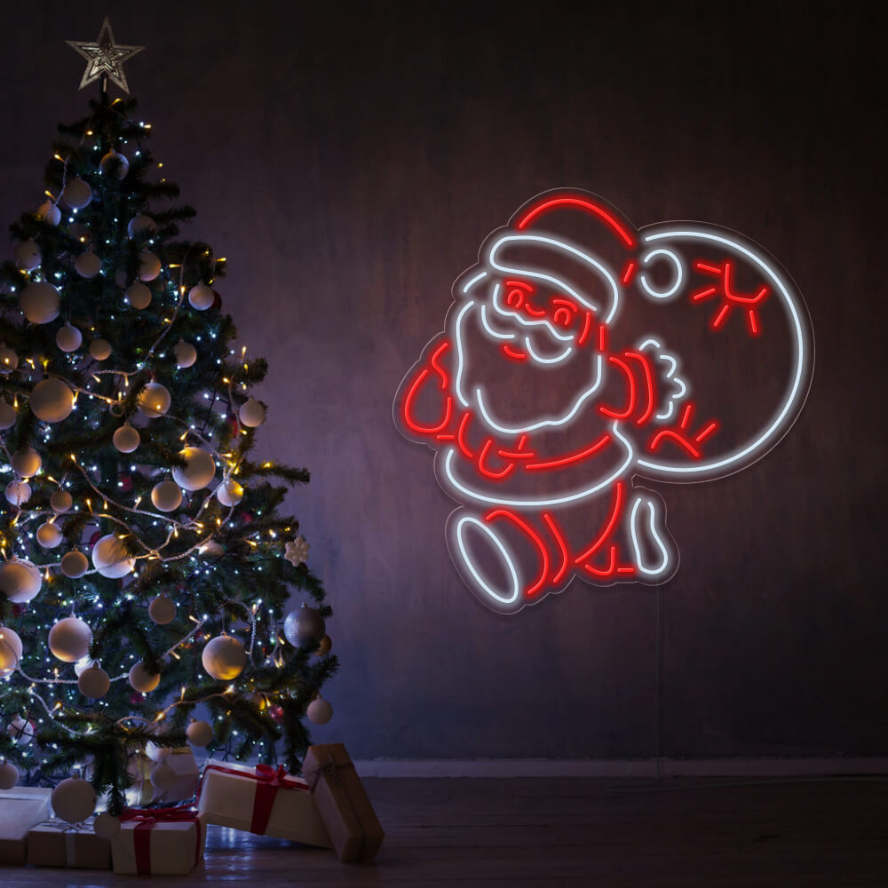 santa claus neon sign hanging on living room wall next to christmas tree