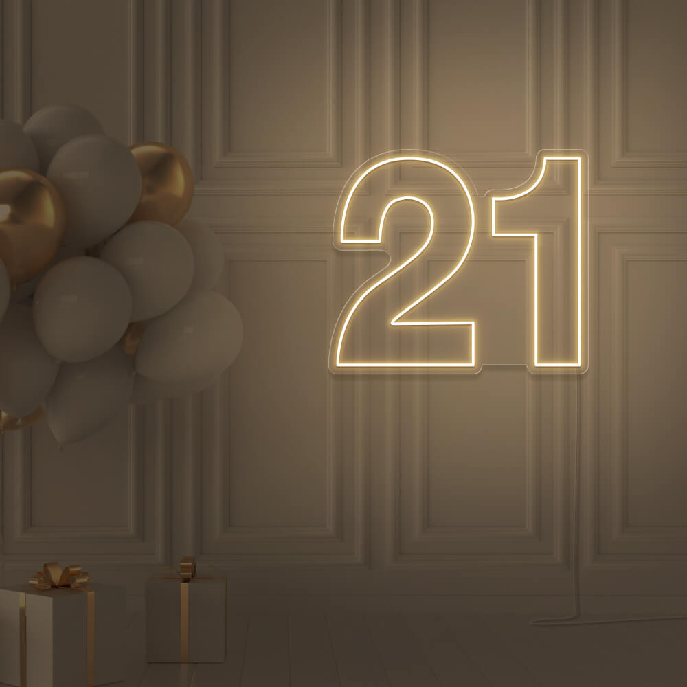 warm white  21 neon sign hanging on wall with balloons