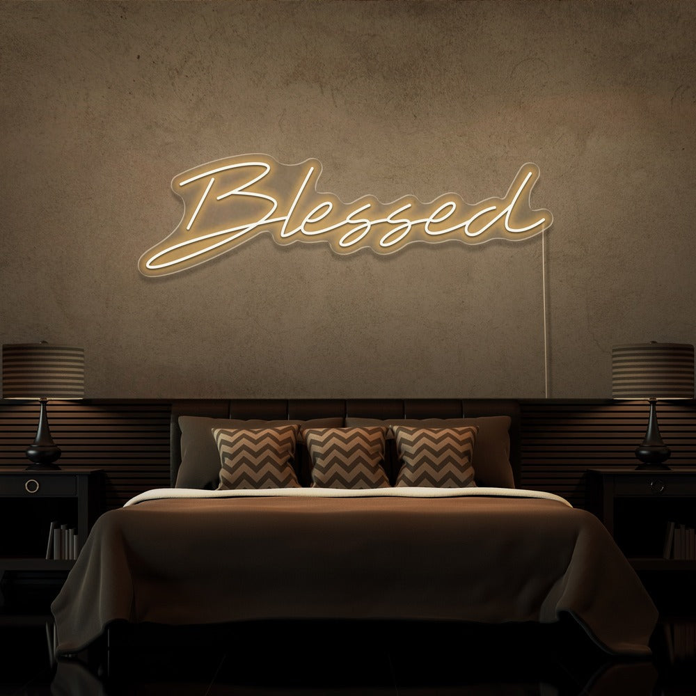 warm white blessed neon sign hanging on bedroom wall