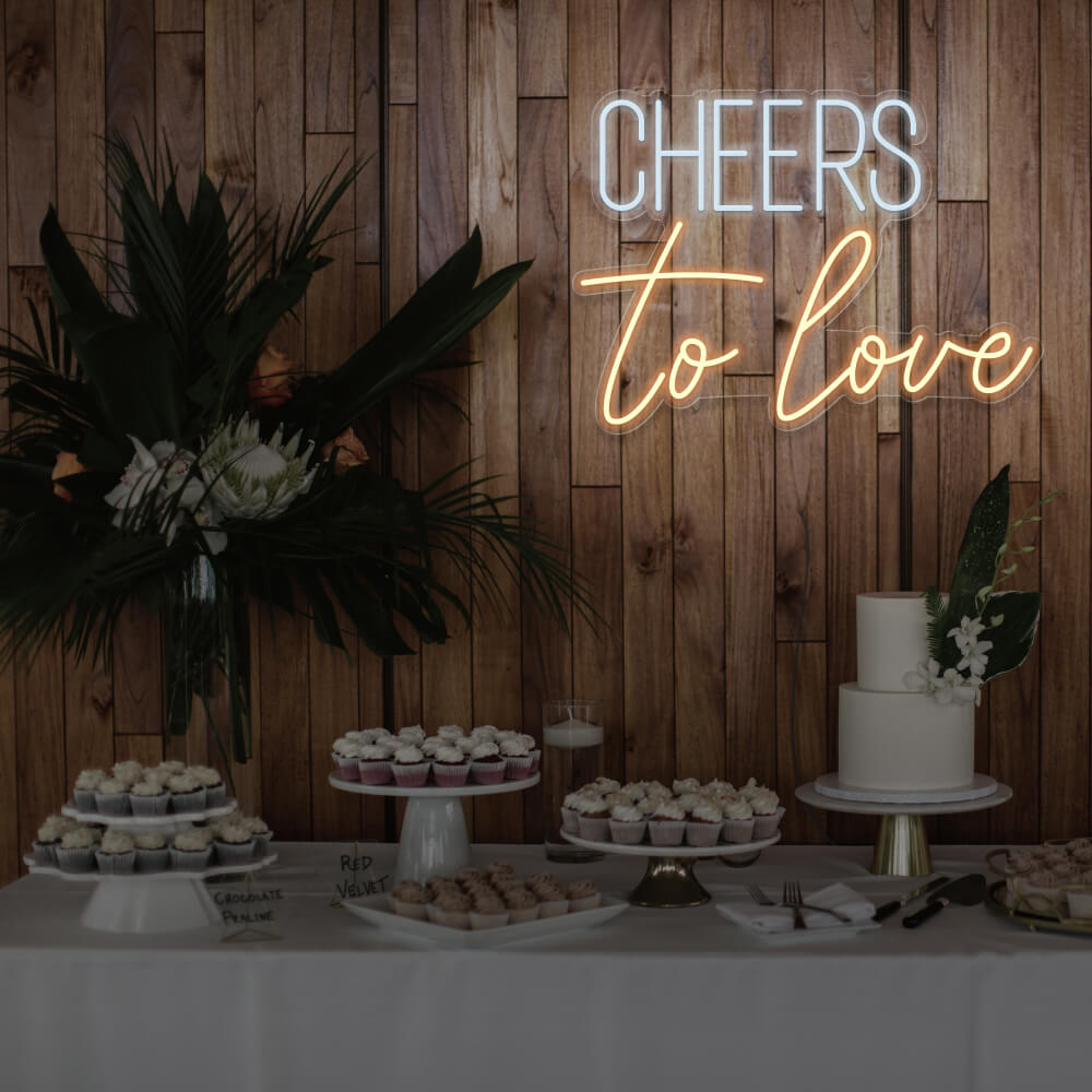 warm white cheers to love neon sign hanging above dessert table