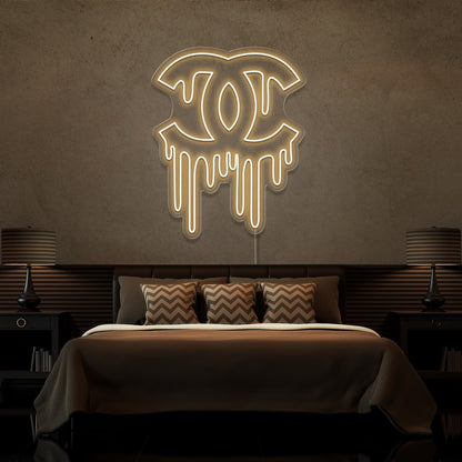 warm white dripping chanel neon sign hanging on bedroom wall