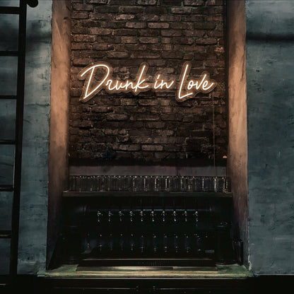 white drunk in love neon sign hanging on bar wall