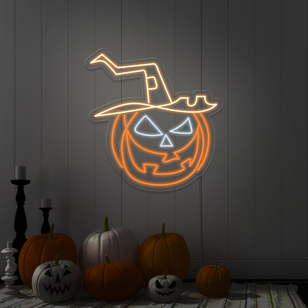 warm white pumpkin hat neon sign hanging on wall next to pumpkins