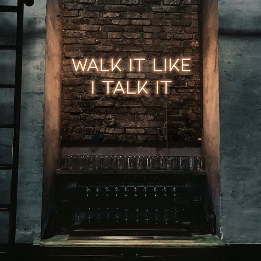 warm white walk it like i talk it neon sign hanging on bar wall