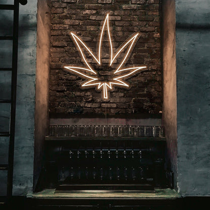 warm white weed leaf neon sign hanging on bar wall