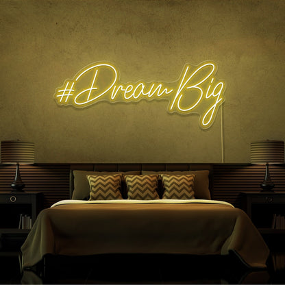 yellow dream big neon sign hanging on bedroom wall