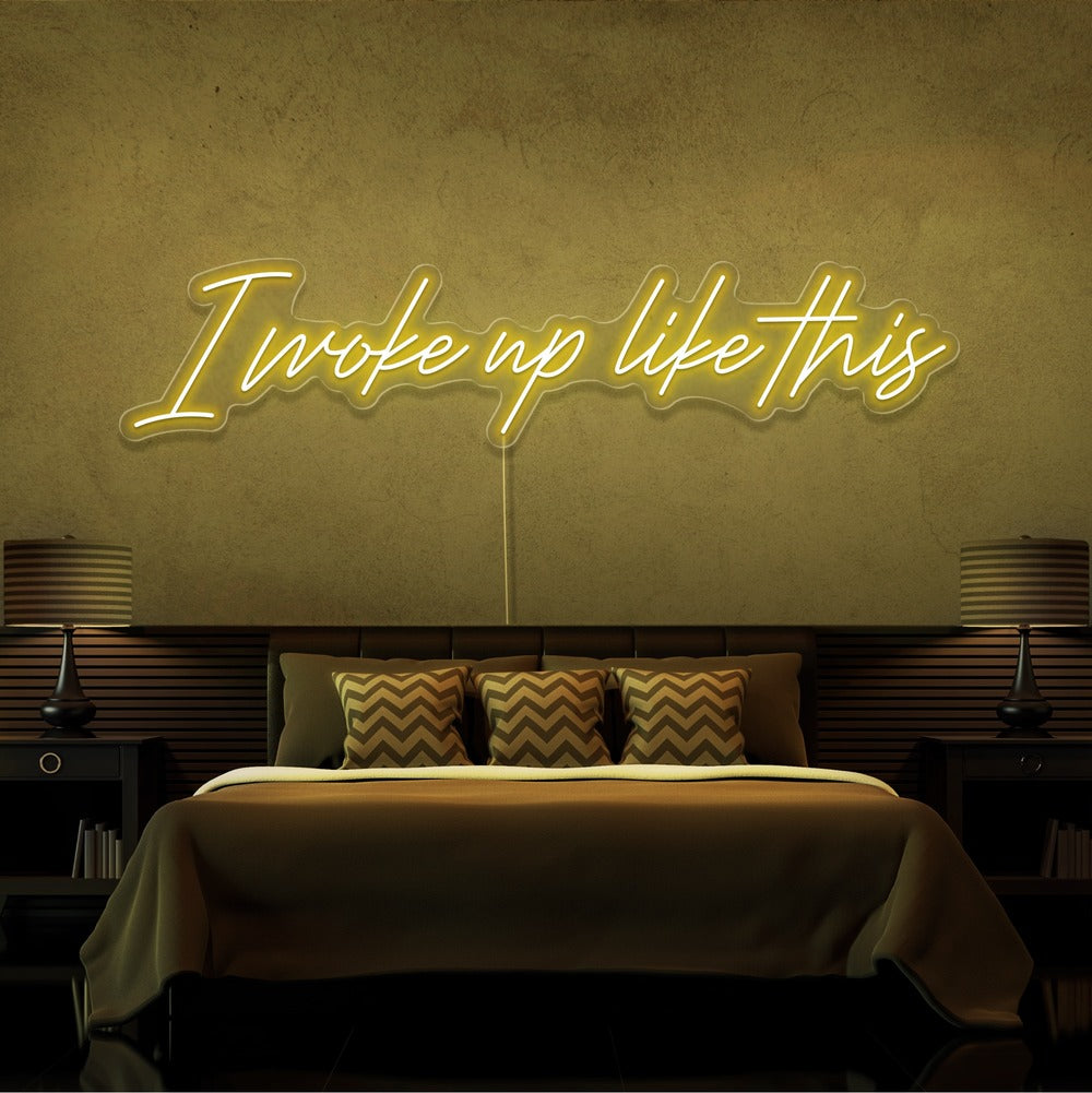 yellow i woke up like this neon sign hanging on bedroom wall