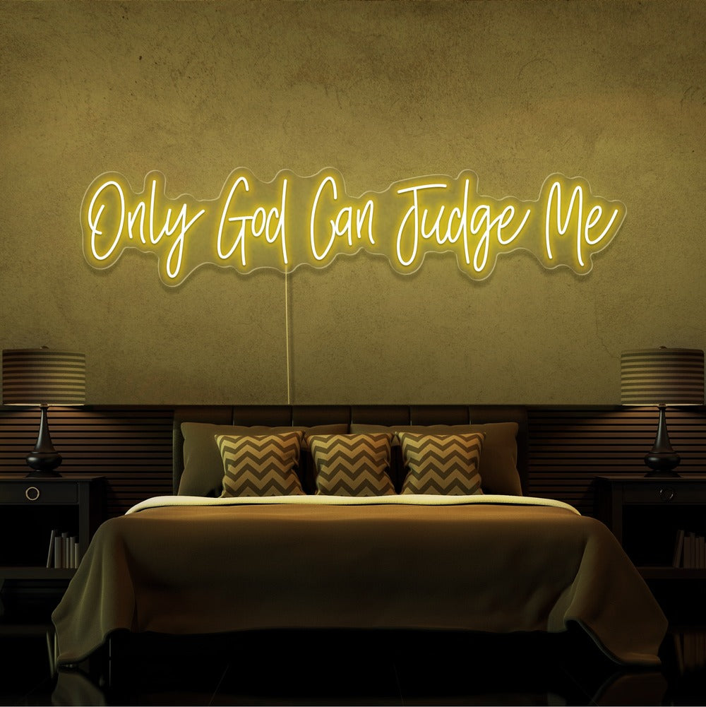 yellow only god can judge me neon sign hanging on bedroom wall