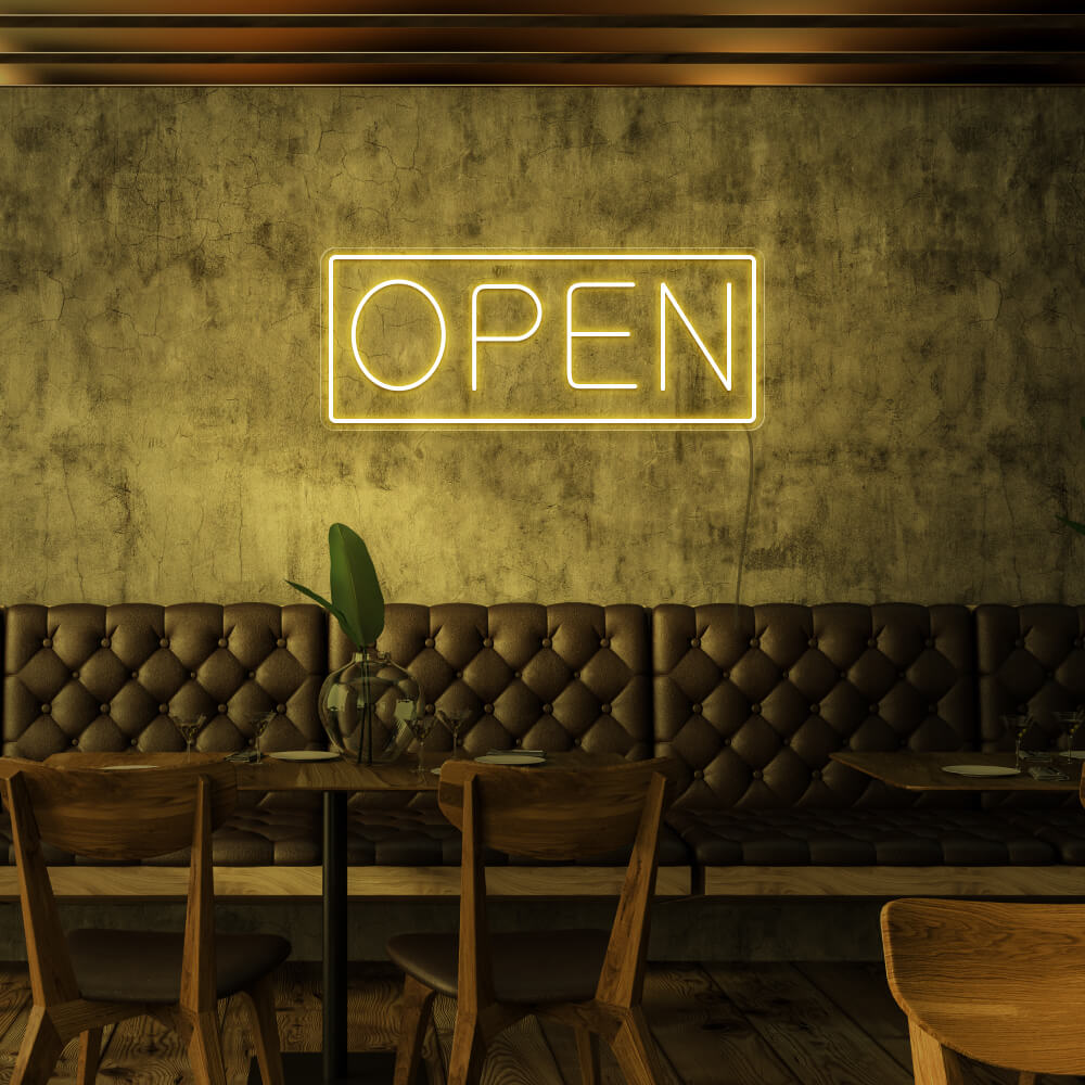 yellow open neon sign hanging on cafe wall