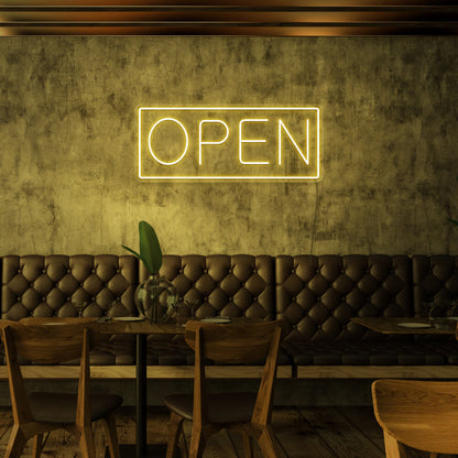 yellow open neon sign hanging on cafe wall