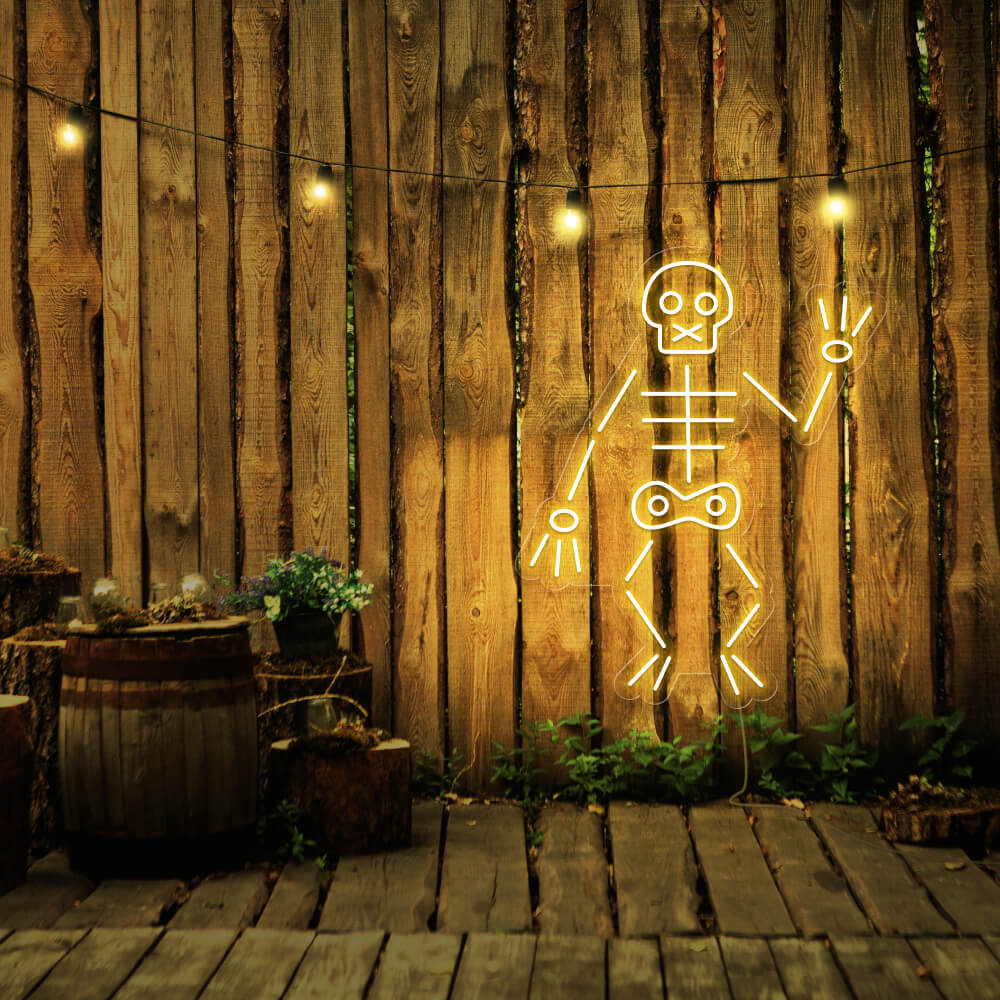 yellow skeleton neon sign hanging on timber fence